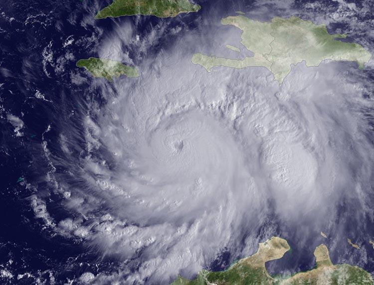A satellite image of Hurricane Matthew sitting over the central Caribbea...