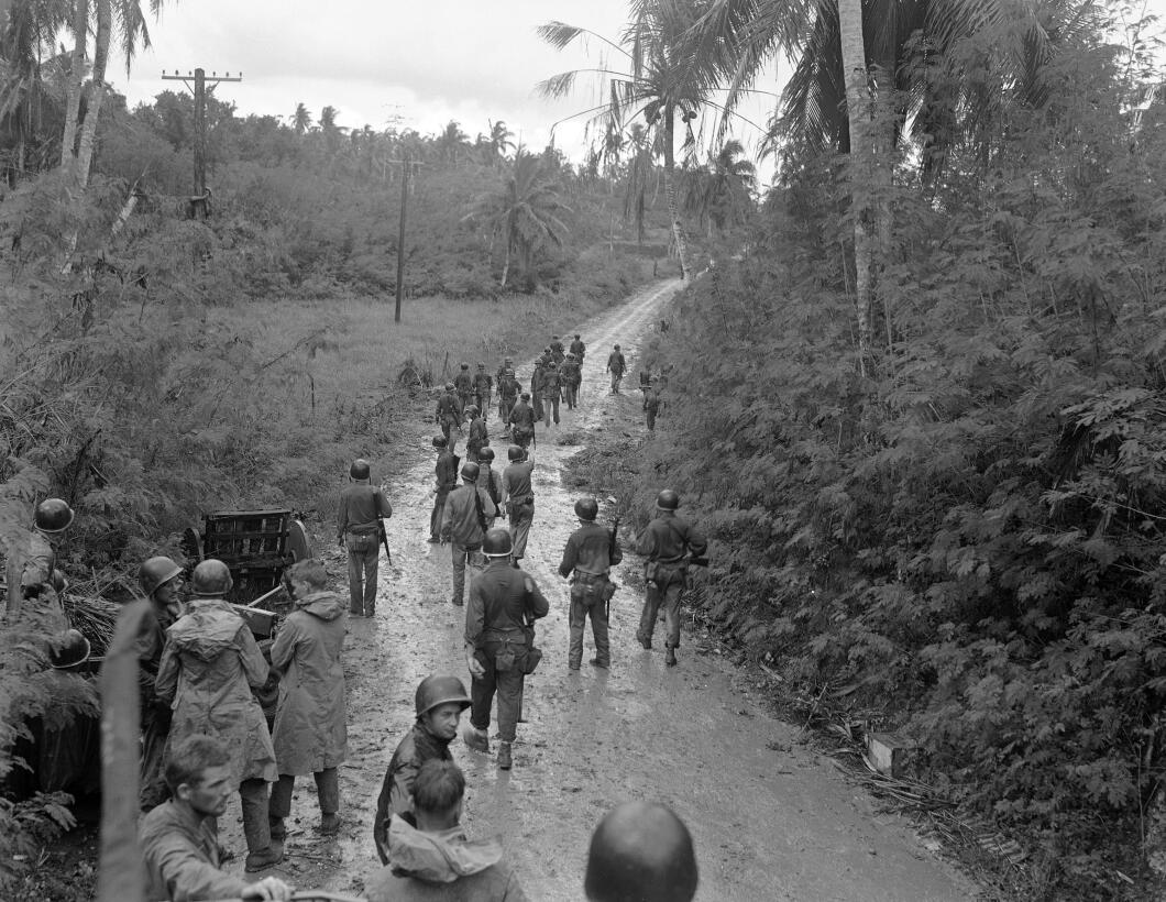 U.S. Marines move forward in the rain, toward junction with 1st Marine B...