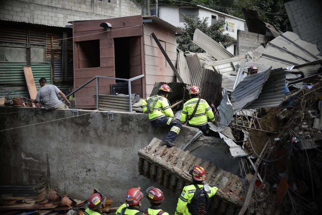 Rescuers search for victims after a landslide at Cambray village, in San...
